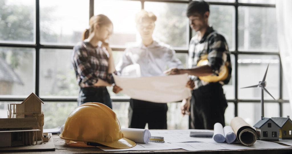 Photo of construction project team with commercial real estate developer discussing constructability review.